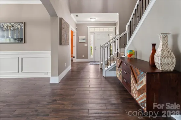 a view of entryway and hall with wooden floor