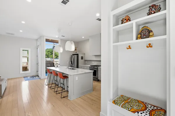a kitchen with a refrigerator and a stove top oven