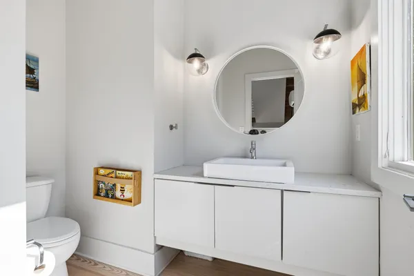 a bathroom with a toilet sink and mirror
