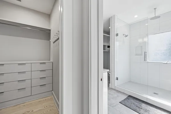 a bathroom with a shower sink and mirror