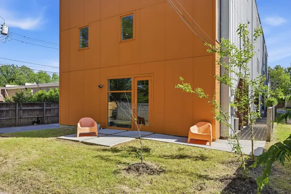 a backyard of a house with table and chairs