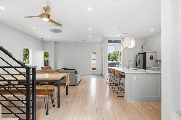 a dining room with furniture and wooden floor