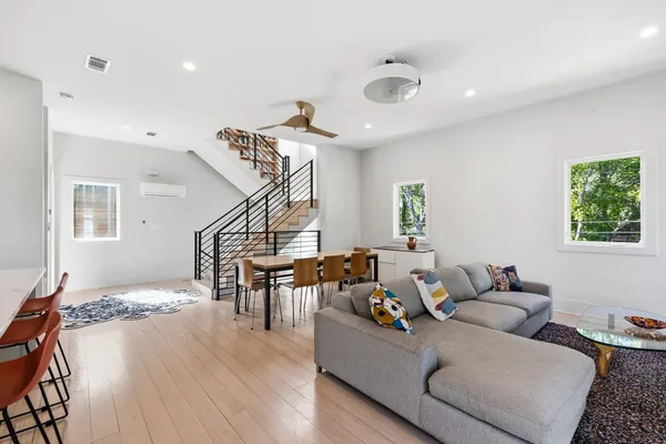 a living room with furniture and wooden floor