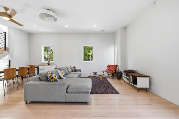 a living room with furniture and a wooden floor