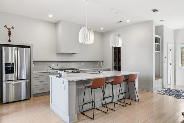a kitchen with a stove a refrigerator and a dining table