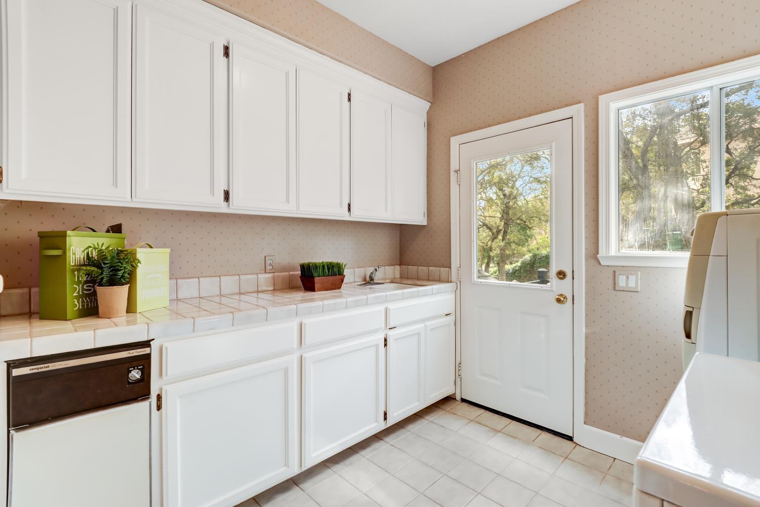 3058 Ridgeview Drive El Dorado Hills, CA 95762 - Photo 33 of 73 a kitchen with white cabinets and white appliances