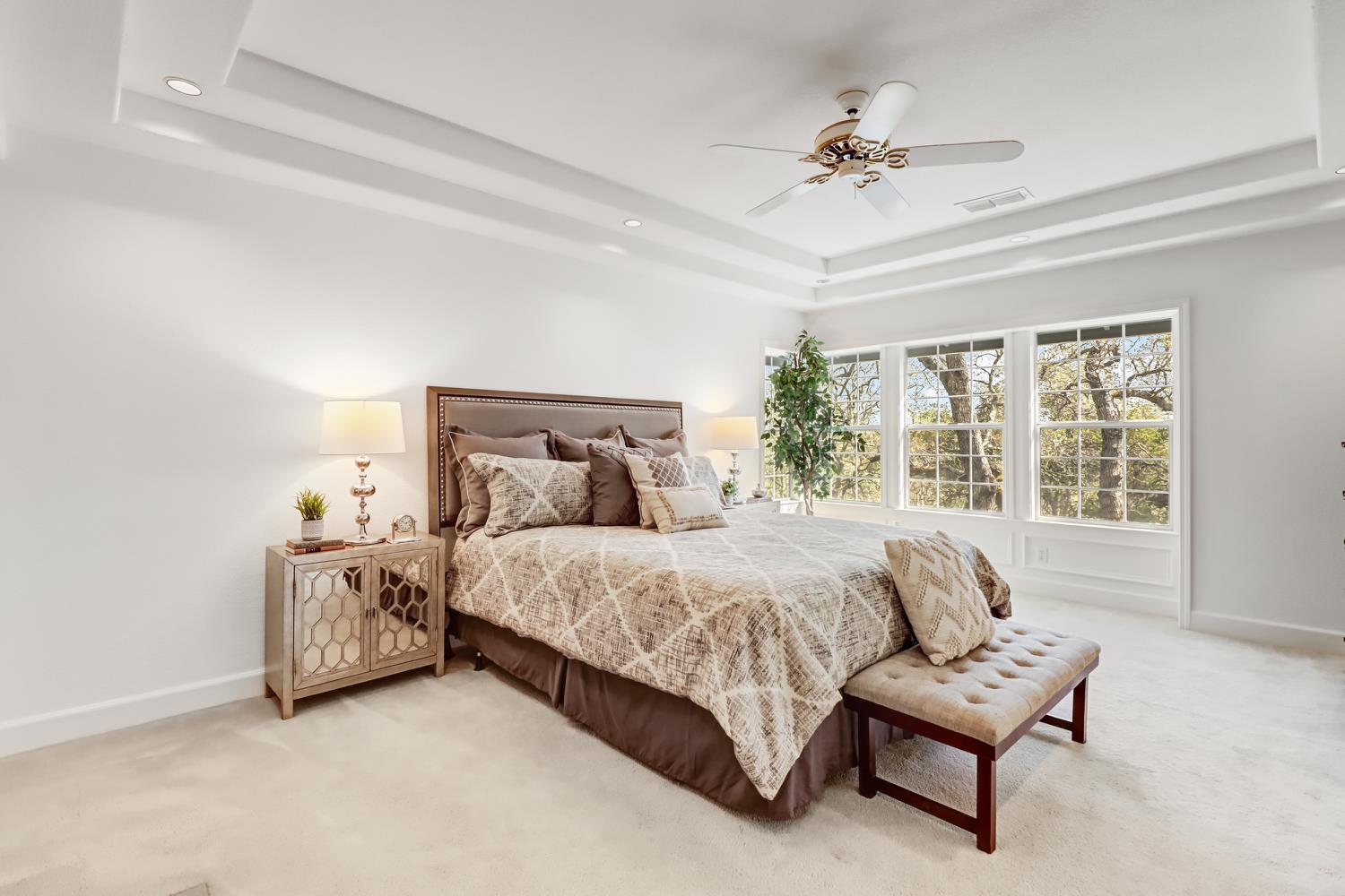 3058 Ridgeview Drive El Dorado Hills, CA 95762 - Photo 39 of 73 a spacious bedroom with a bed and a chandelier