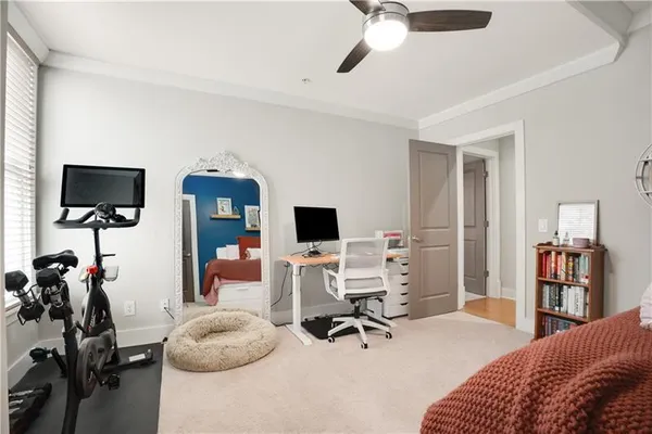 a bedroom with a workspace