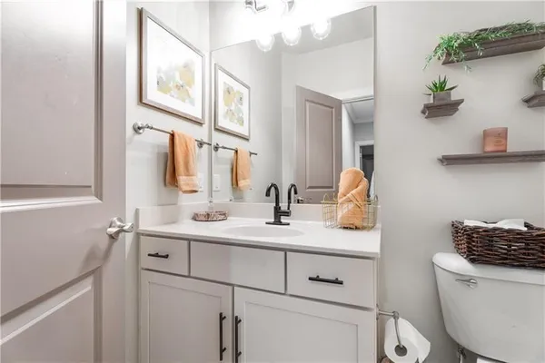a bathroom with a toilet sink and mirror
