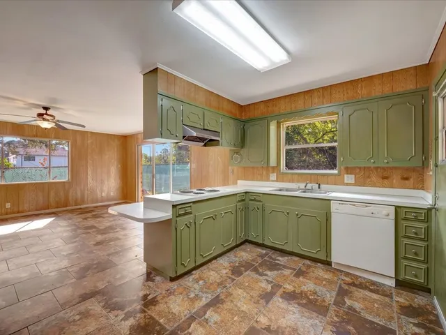 a kitchen with granite countertop a sink and cabinets