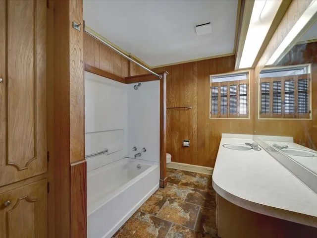 a bathroom with a bathtub and a shower