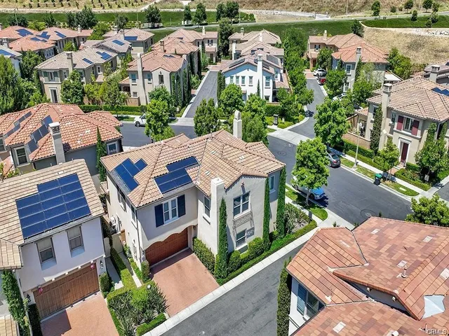 an aerial view of multiple houses with yard