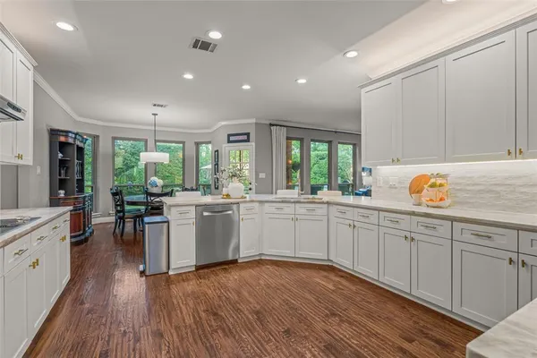a kitchen with sink cabinets and wooden floor