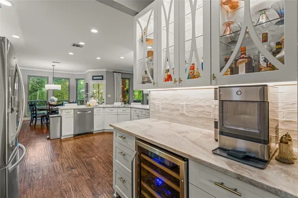 a kitchen with stainless steel appliances granite countertop a stove and a refrigerator
