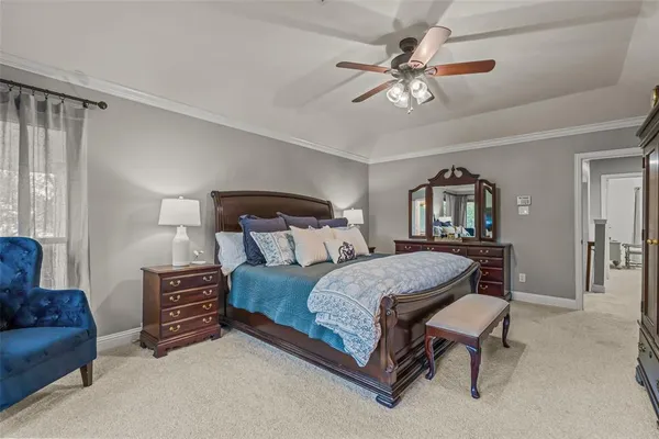 a bedroom with a bed a couch and a chandelier