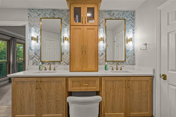 a bathroom with a double vanity sink mirror and toilet
