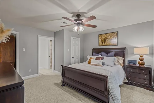 a bedroom with a bed and a chandelier