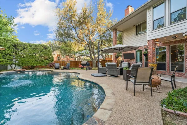 a view of a swimming pool with chairs in patio