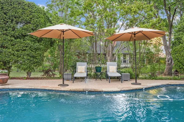 a view of a fire pit with an umbrella in patio