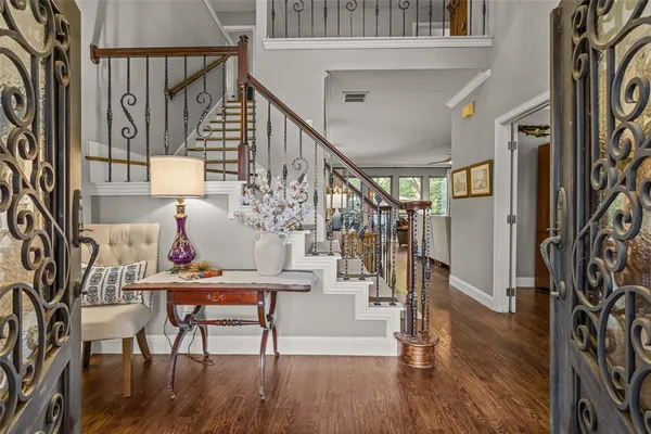 a view of entryway and hall with wooden floor