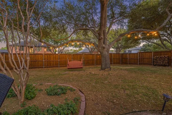 a view of a backyard with large trees