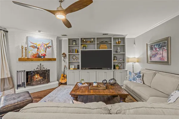 a living room with furniture and a fireplace