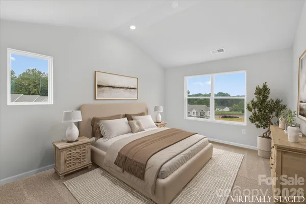 a bedroom with a bed and a large window