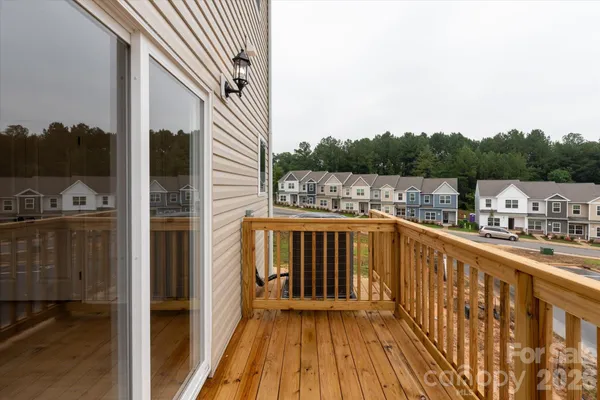 a view of a balcony with wooden floor