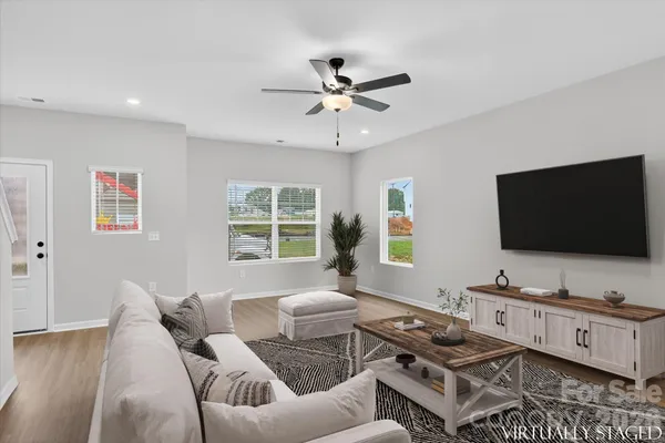 a living room with furniture and a flat screen tv