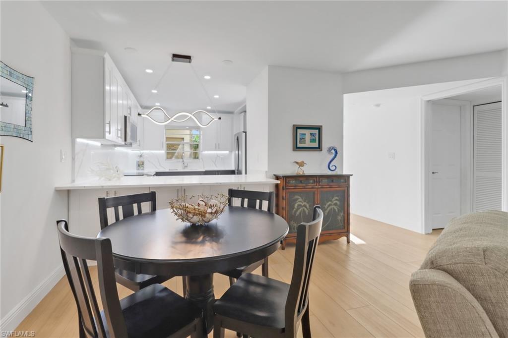 1200 Cherrystone Court, Unit A104 Naples, FL 34102 - Photo 11 of 29 Dining area featuring visible vents, baseboards, light wood-style floors, and recessed lighting