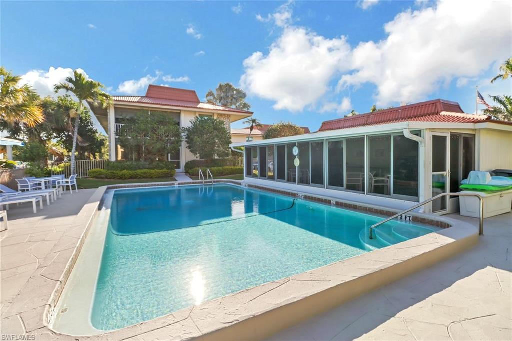 1200 Cherrystone Court, Unit A104 Naples, FL 34102 - Photo 25 of 29 View of swimming pool with fence, a sunroom, a patio area, and a fenced in pool