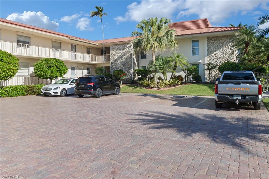 1200 Cherrystone Court, Unit A104 Naples, FL 34102 - Photo 27 of 29 View of property featuring uncovered parking