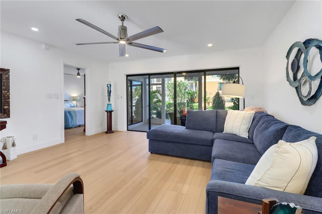 1200 Cherrystone Court, Unit A104 Naples, FL 34102 - Photo 9 of 29 Living area featuring baseboards, light wood-style flooring, recessed lighting, and a ceiling fan