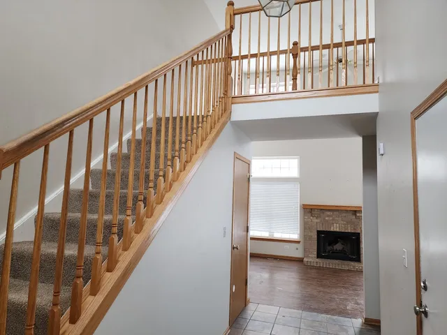 a view of staircase with white walls and a floor to ceiling window