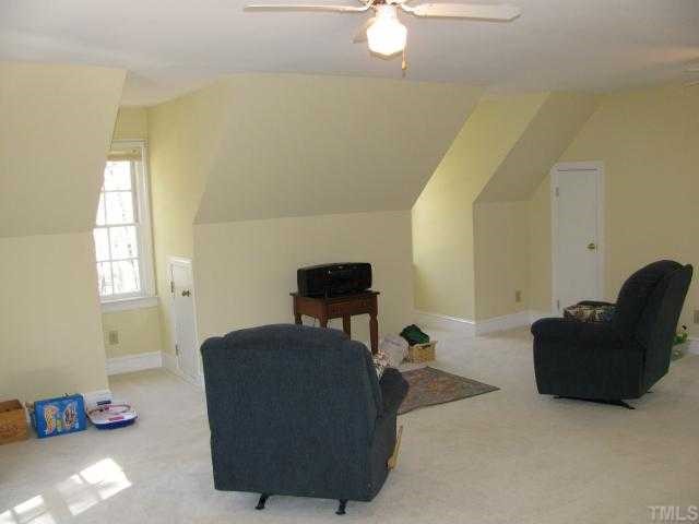 10604 Dunhill Terrace Raleigh, NC 27615 - Photo 9 of 12 a living room with furniture and a lamp