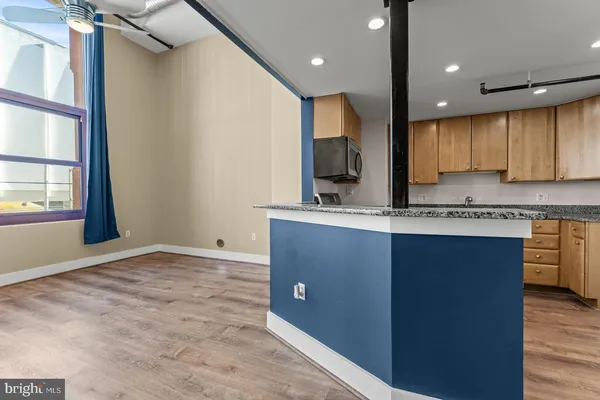 a kitchen with stainless steel appliances granite countertop a sink a stove and a refrigerator