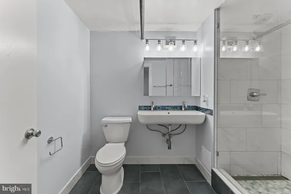 a bathroom with a sink toilet and shower