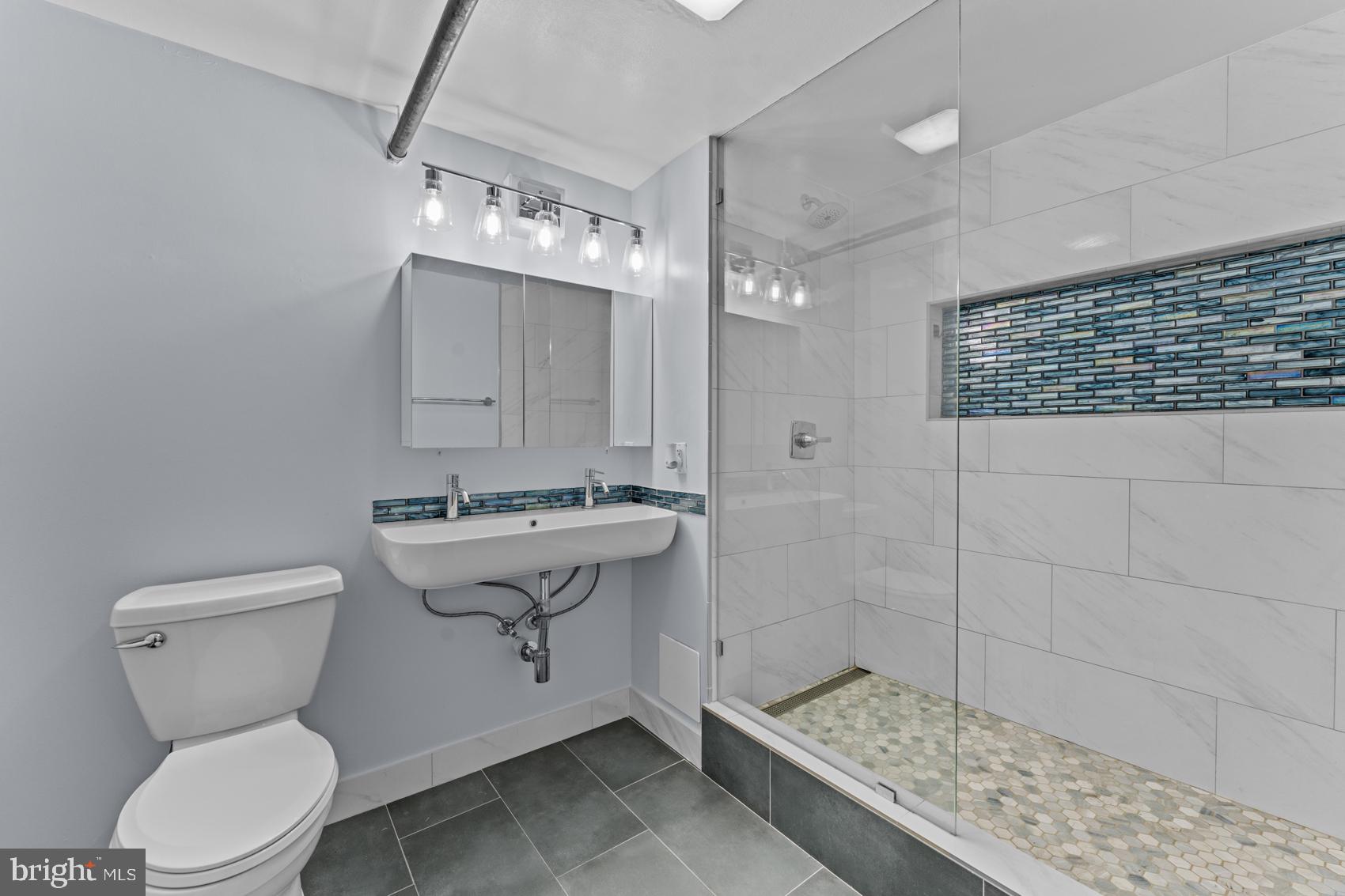 22 South Howard Street, Unit R201 Baltimore, MD 21201 - Photo 30 of 34 a bathroom with a sink toilet and shower