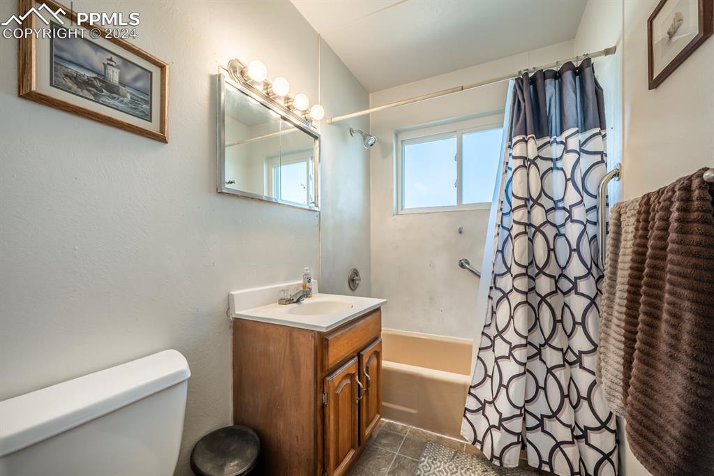 91 Duke Street Pueblo, CO 81005 - Photo 11 of 30 a bathroom with a sink and mirror with toilet