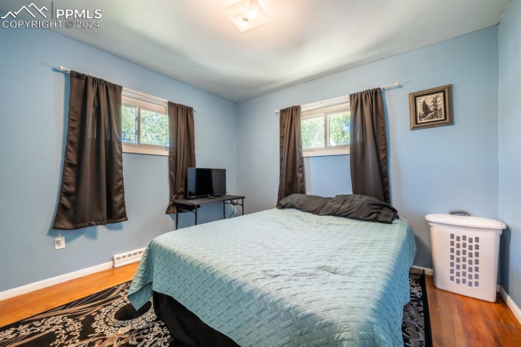 91 Duke Street Pueblo, CO 81005 - Photo 13 of 30 a bedroom with a bed and a flat tv screen on dresser