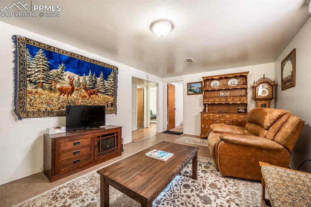 91 Duke Street Pueblo, CO 81005 - Photo 16 of 30 a living room with furniture and a flat screen tv