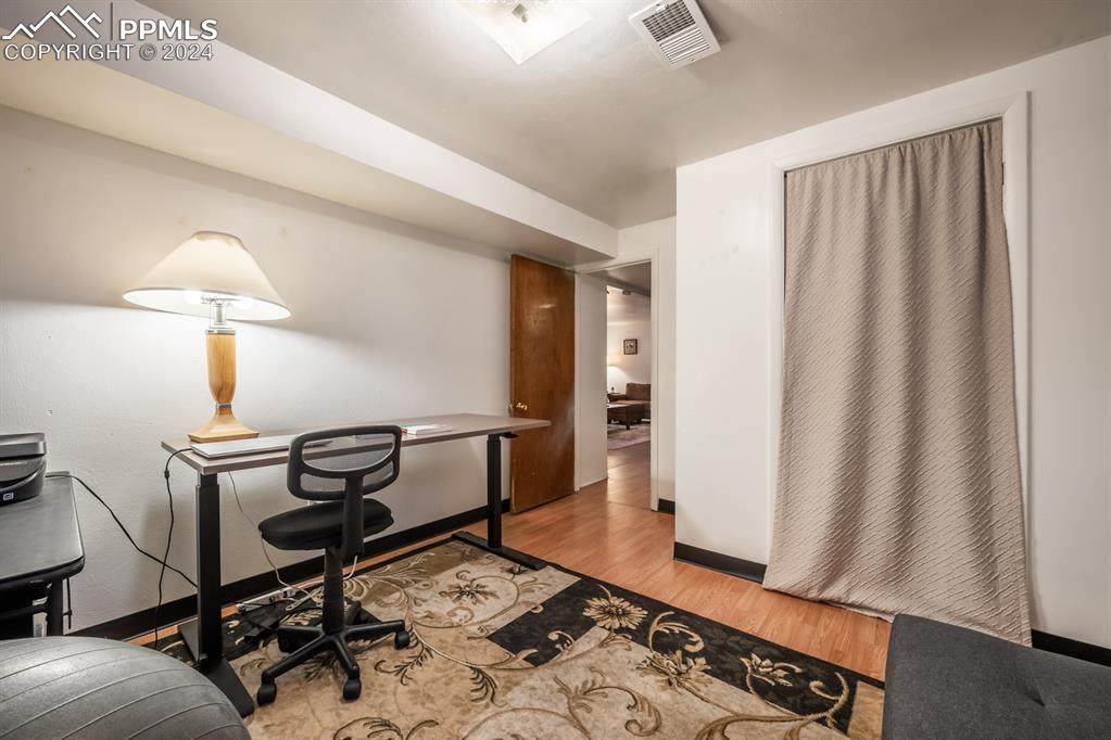 91 Duke Street Pueblo, CO 81005 - Photo 18 of 30 a view of a workspace with furniture and a window