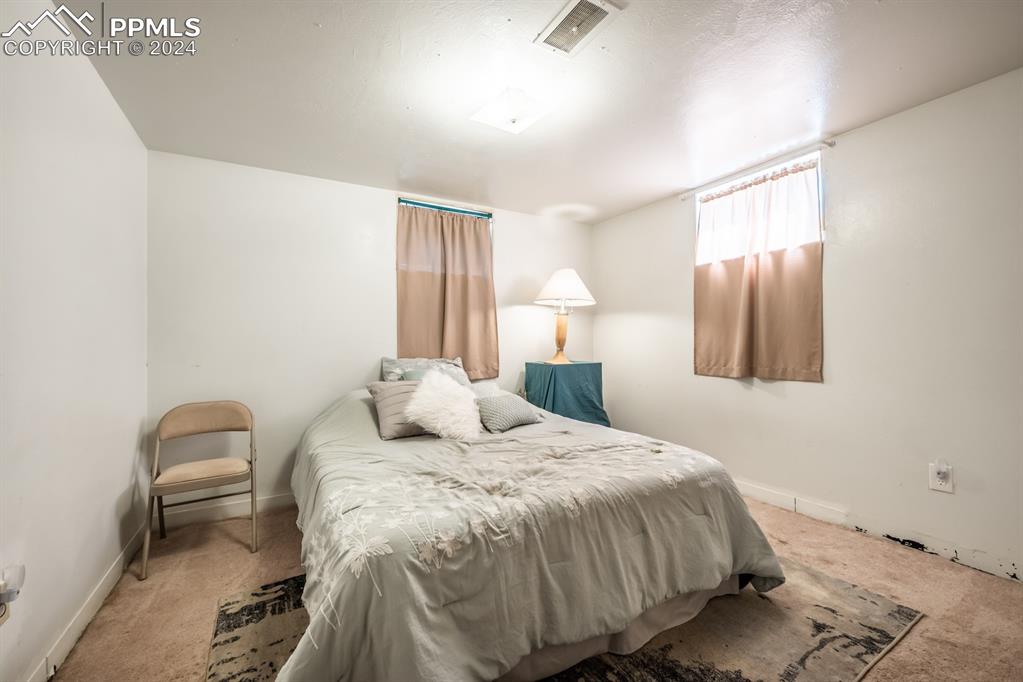91 Duke Street Pueblo, CO 81005 - Photo 21 of 30 a bedroom with a bed and a lamp