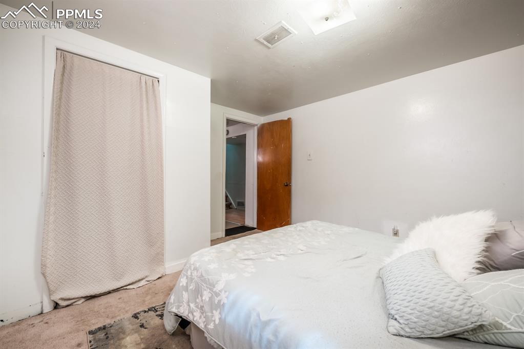 91 Duke Street Pueblo, CO 81005 - Photo 22 of 30 a bedroom with a bed and a window
