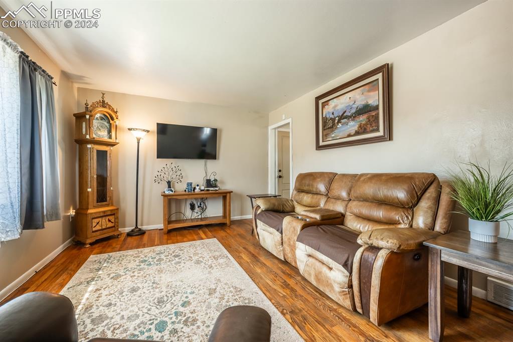 91 Duke Street Pueblo, CO 81005 - Photo 4 of 30 a living room with furniture and a flat screen tv