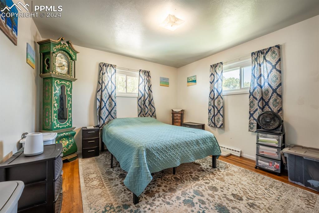 91 Duke Street Pueblo, CO 81005 - Photo 9 of 30 a bedroom with a bed and a table in it