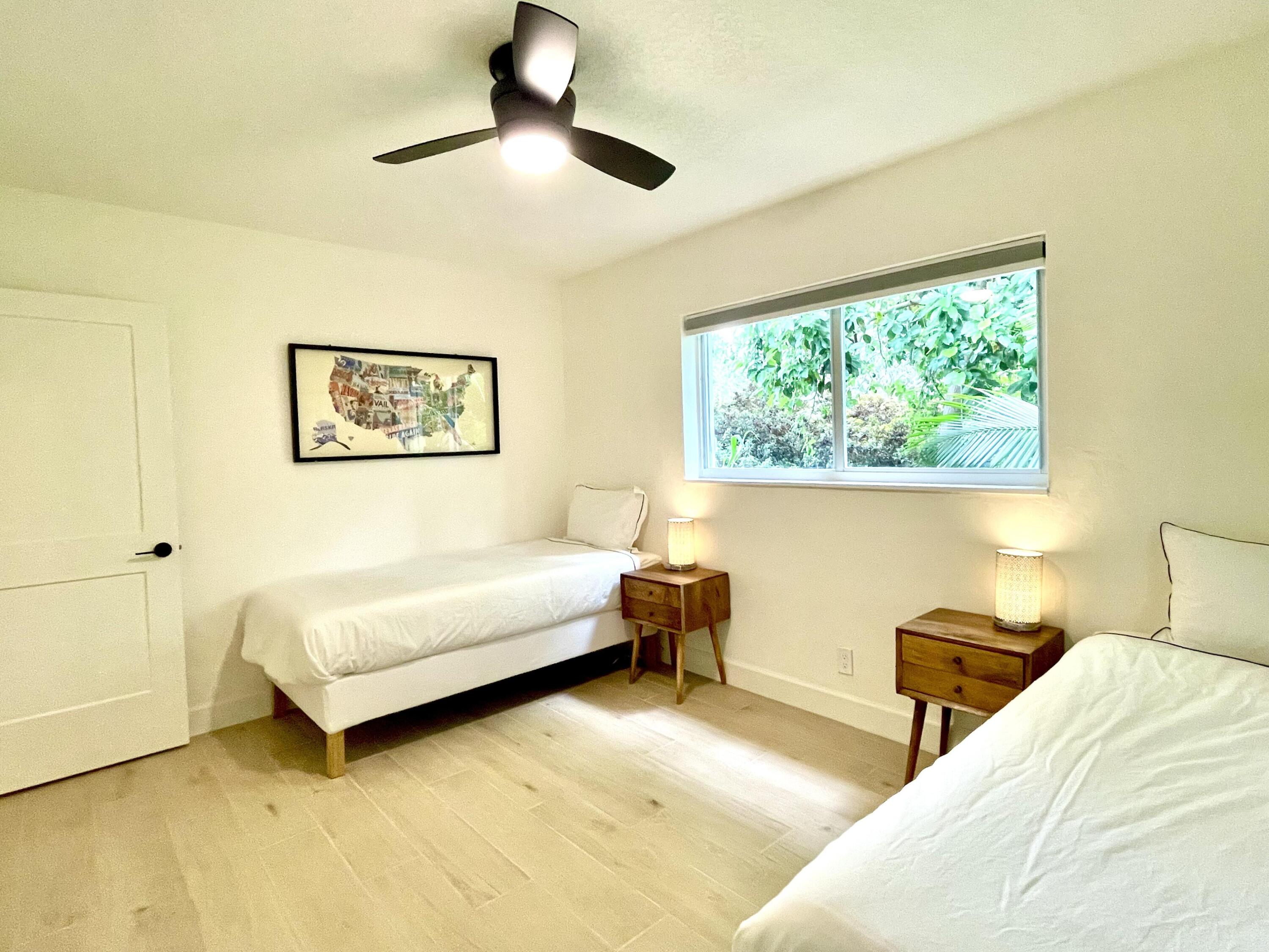 921 Northwest 7th Street Boca Raton, FL 33486 - Photo 11 of 18 a bedroom with a bed and a large window