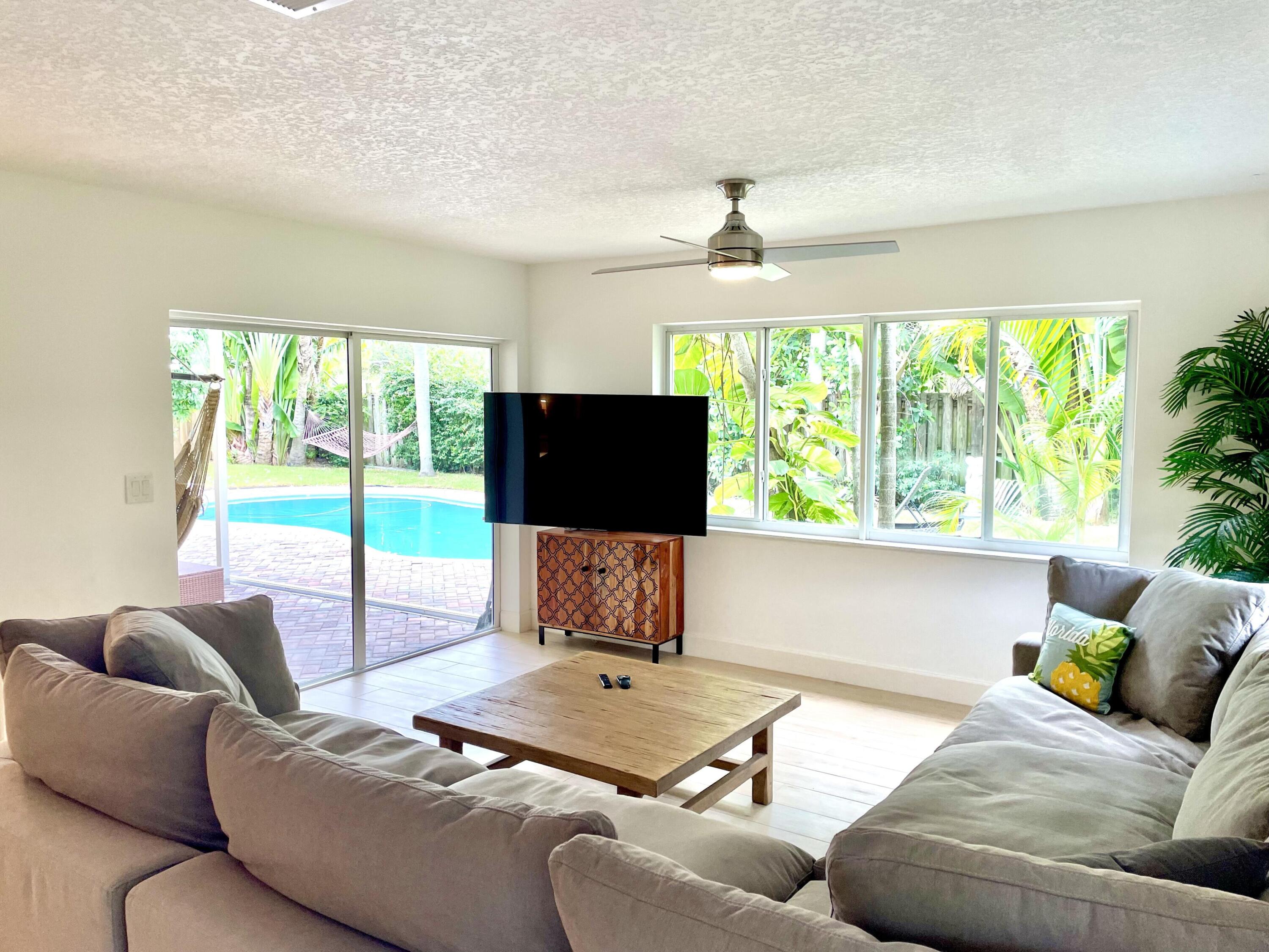 921 Northwest 7th Street Boca Raton, FL 33486 - Photo 13 of 18 a living room with furniture and a flat screen tv