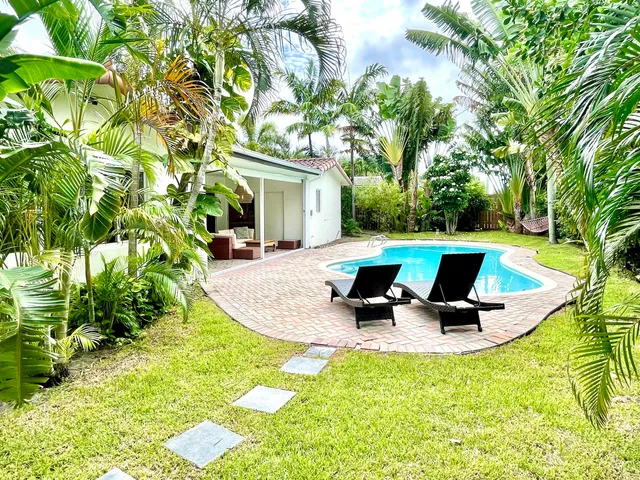 a view of a swimming pool with sitting area