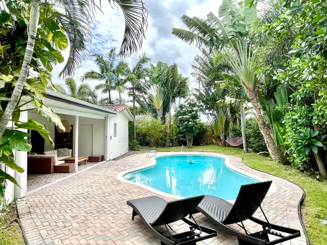 a view of a swimming pool with chair and tables